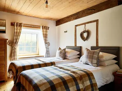 two beds in a room with a window at Bedlwyncoch Farmhouse in Brecon