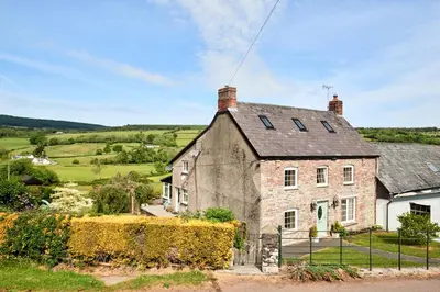 an old stone house in the countryside at Bedlwyncoch Farmhouse in Brecon