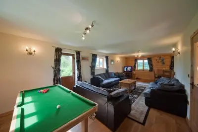 a living room with a pool table at Poplar Tree Eco Lodge in Brecon