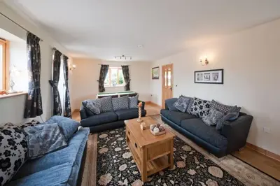 a living room with two couches and a coffee table at Beech Tree Eco Lodge in Brecon