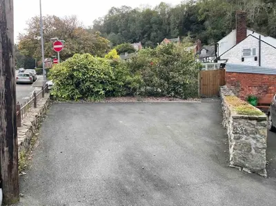 an empty parking lot with a stop sign on a street at Ty Twty, Montgomery Cottage in Montgomery