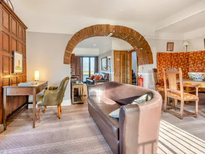 a living room with a couch and a table at Morlais in Llanon