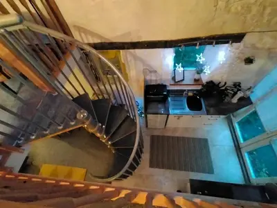 an overhead view of a spiral staircase in a house at Yr Hen Efail - Quirky Old Smithy cottage near forest walks, cycling & lakes in Garthbeibio