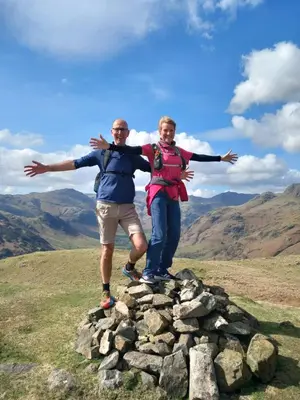 a man and woman standing on top of a mountain at Yr Hen Efail - Quirky Old Smithy cottage near forest walks, cycling & lakes in Garthbeibio