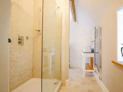a bathroom with a shower with a glass door at 1 Bed in Ty Nant 52509 in Corwen