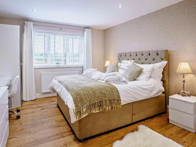 a bedroom with a large bed and a window at 2 Bed in Lampeter oc-75211 in Mydroilin
