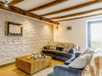 a living room with two couches and a stone wall at 2 Bed in Brecon oc-bn310 in Cray