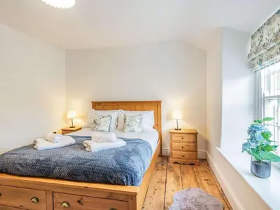 a bedroom with a bed with two pillows on it at 3 Bed in Corwen oc-86266 in Corwen