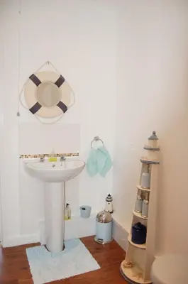 a bathroom with a sink and a mirror at Beach Vista Apartment One in Barmouth in Barmouth