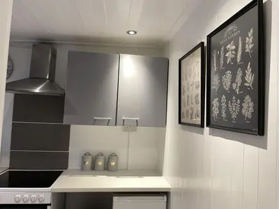 a kitchen with a stove and a counter top at Beach Vista Apartment Three in Barmouth in Barmouth