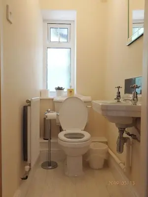 a bathroom with a toilet and a sink at Bryn Mair in Barmouth in Barmouth