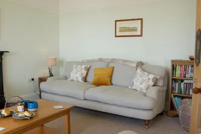 a living room with a couch with pillows on it at Bryn Mair in Barmouth in Barmouth
