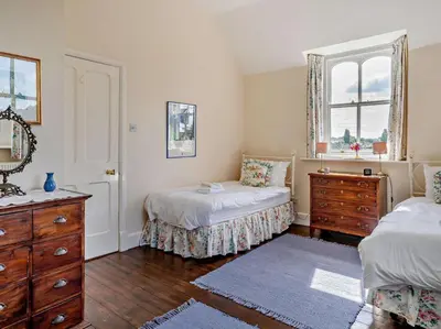 a bedroom with two beds and a dresser and a window at 3 Bed in Brecon oc-bn134 in Brecon