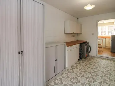 a kitchen with white cabinets and a tile floor at Ludlow House in Ludlow