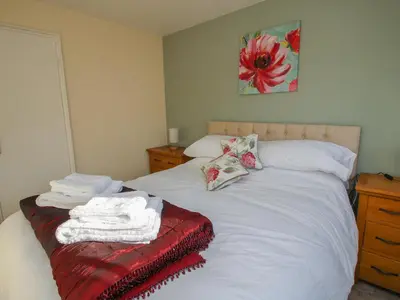 a bedroom with two beds with towels on them at Ludlow House in Ludlow