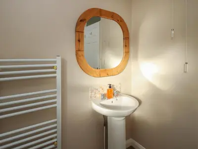 a bathroom with a sink and a mirror at Ludlow House in Ludlow