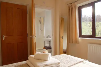 a bathroom with a bed with towels on it at Ty Pen y Bryn in Dolgellau in Dolgellau