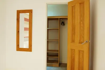 a room with a closet with a wooden door at Tawel Fryn Bungalow near Dolgellau in Dolgellau