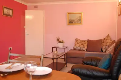 a living room with a couch and a table at Wulfrun in Tywyn