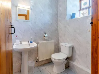 a bathroom with a toilet and a sink at 1 Bed in Llanybydder oc-81354 in Llanwenog