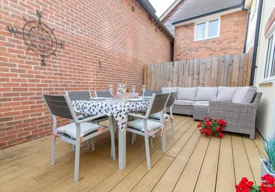 a patio with a table and chairs and a couch at Elegant Ludlow Haven: 4Bed Ultimate Tranquility in Ludlow