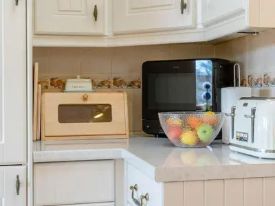 a kitchen with a microwave and a bowl of fruit on a counter at 1 Bed in Lampeter oc-43288 in Tregaron