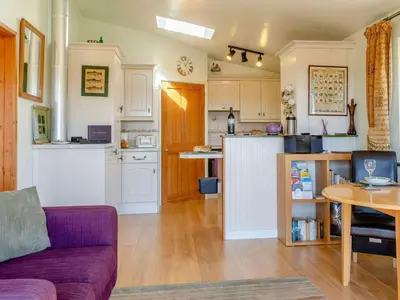 a living room with a couch and a kitchen at 1 Bed in Lampeter oc-43288 in Tregaron