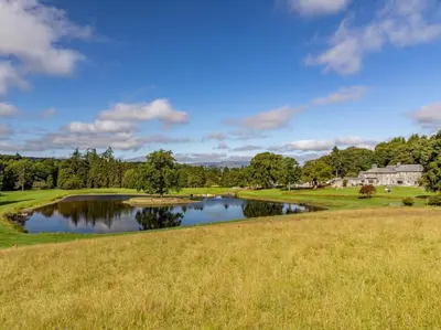 a view of a pond on a golf course at 4 Bed in Bala oc-75288 in Llandderfel