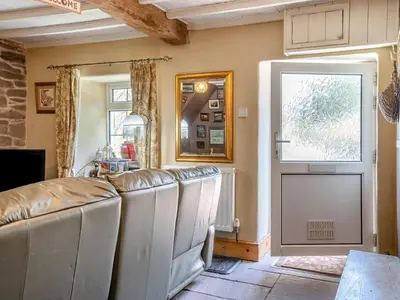 a room with a bunch of leather chairs and a door at 2 Bed in Llanfihangel-nant-Bran BN200 in Llanfihangel-Nant-Brân