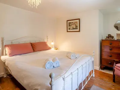 a bedroom with a white bed with towels on it at 2 Bed in Llanfihangel-nant-Bran BN200 in Llanfihangel-Nant-Brân