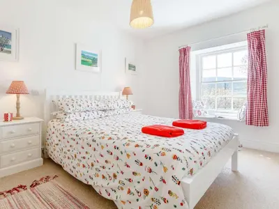 a bedroom with a bed with red pillows on it at 3 Bed in Brecon oc-bn331 in Cathedine