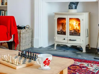 a living room with a chess board and a fireplace at 3 Bed in Brecon oc-bn331 in Cathedine