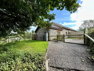 an old stone house with a gate and a yard at 1 Bed in Aberystwyth oc-83551 in Llanilar