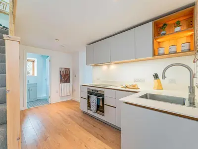 a kitchen with white cabinets and a sink at 1 Bed in Aberystwyth oc-83551 in Llanilar