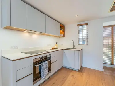 a kitchen with white cabinets and a sink at 1 Bed in Aberystwyth oc-83551 in Llanilar