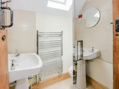 a bathroom with two sinks and a toilet at 4 Bed in Llandinam oc-51651 in Llandinam