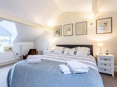 a bedroom with a large bed with towels on it at 1 Bed in Presteigne oc-53667 in Presteigne