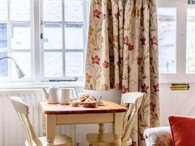 a dining room table with chairs and a window at 1 Bed in Presteigne oc-53667 in Presteigne