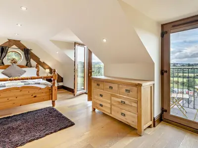 a bedroom with a bed and a large window at 2 Bed in Corwen oc-77351 in Corwen