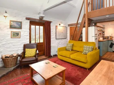 a living room with a yellow couch and a table at 1 Bed in Brecon oc-bn264 in Brecon