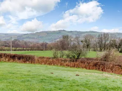 a green field with a hill in the distance at 1 Bed in Brecon oc-bn264 in Brecon