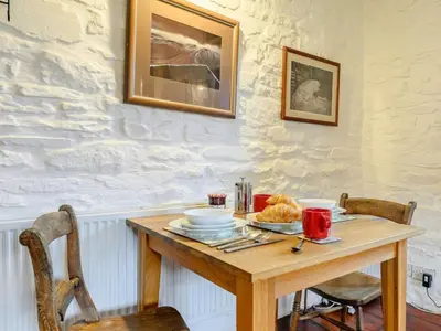 a wooden table with a plate of food on it at 1 Bed in Brecon oc-bn264 in Brecon