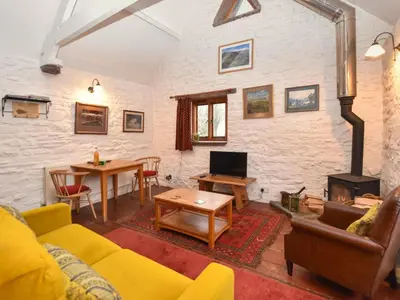 a living room with a yellow couch and a fireplace at 1 Bed in Brecon oc-bn264 in Brecon
