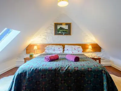 a bedroom with a bed with purple pillows on it at 1 Bed in Brecon oc-bn264 in Brecon