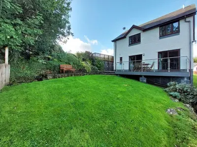 a house with a large yard in front of it at Caer Dderwen Oak Field family home in Dolgellau in Dolgellau