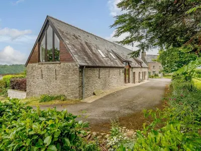 an external view of a stone house with a driveway at 3 Bed in Brecon oc-88249 in Brecon