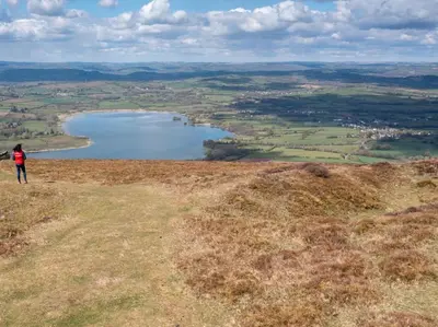 a person standing on top of a hill overlooking a lake at 3 Bed in Brecon oc-88249 in Brecon