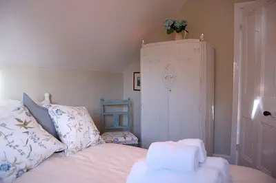 a bedroom with a bed with towels on it at Minafon near Barmouth in Llanaber