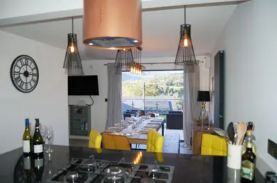 a kitchen with a dining table with yellow chairs at Paradwys in Dolgellau in Dolgellau