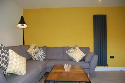 a living room with a couch with pillows on it at Paradwys in Dolgellau in Dolgellau